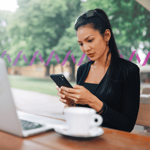 Photoillustration of a woman holding a cell phone with a laptop and a coffee cup in background