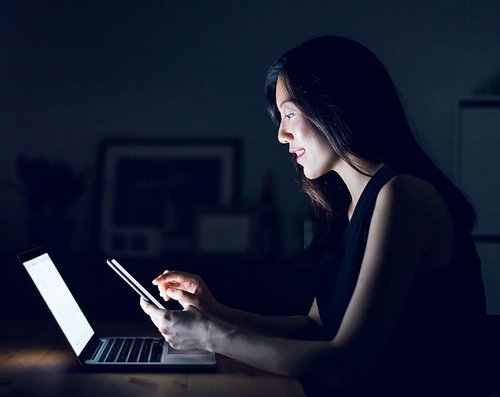 Woman on Phone and Laptop