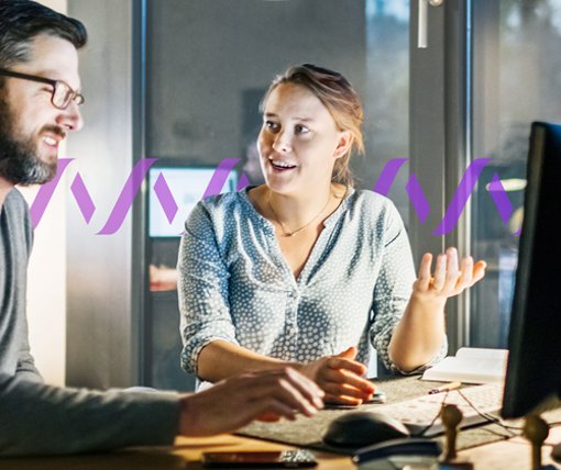 Photo of a team of two work together on a project