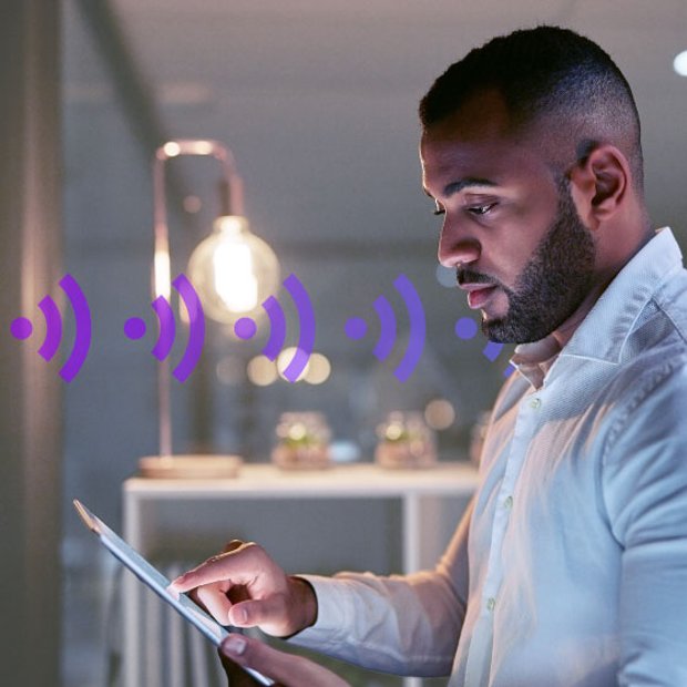 Photo of an employee testing business VoIP call quality and network performance on a tablet.